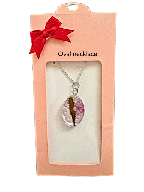 Handmade oval resin necklace with hemp leaf and pink flower