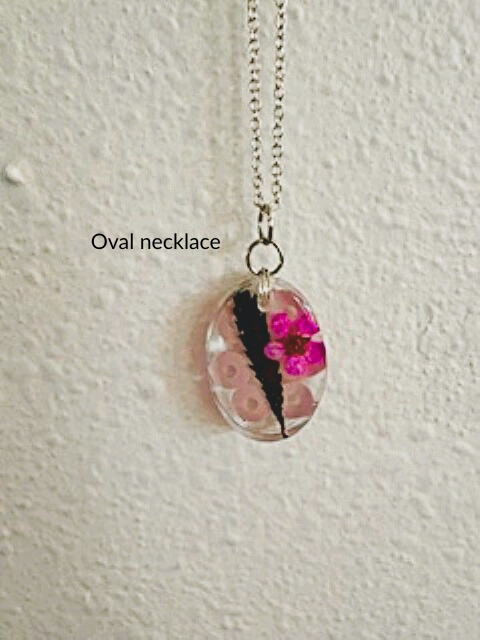 Handmade oval resin necklace with hemp leaf and pink flower